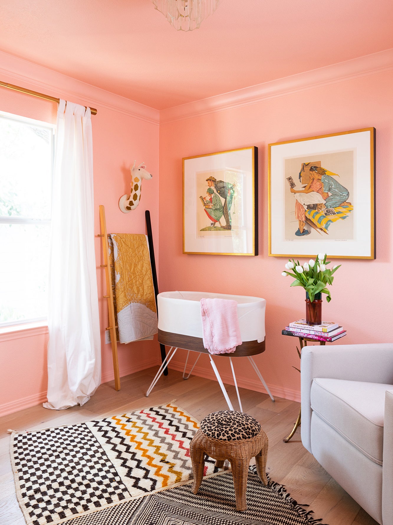 pink nursery with boho striped rug and cheetah print stool