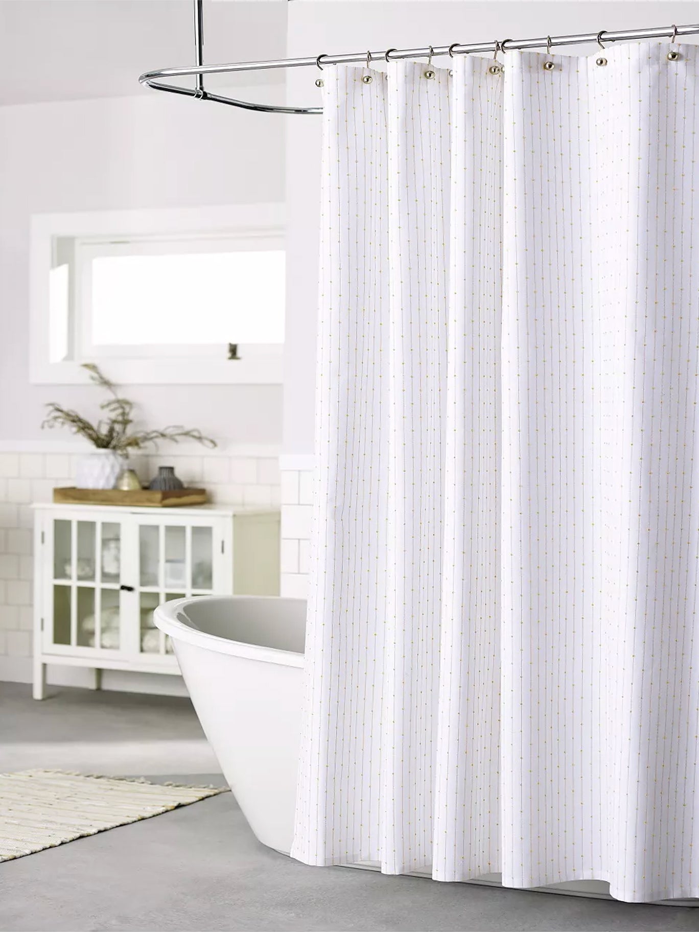 white bathroom with bathtub that has shower curtain