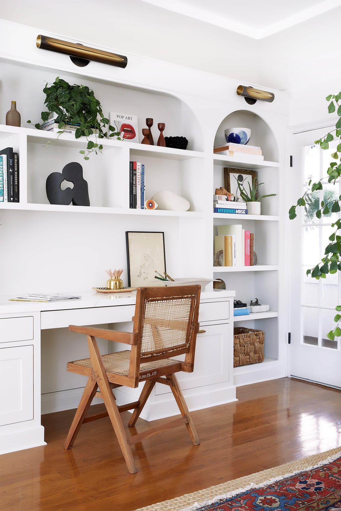 workspace with recessed bookshelves and jeanneret chair