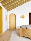 white walls with wood ceiling yellow doorway