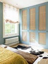Bedroom wardrobes with cane doors and blue walls