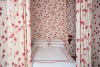 Bedroom with red and white canopy bed and wallpaper