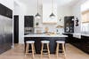 white kitchen with black painted island