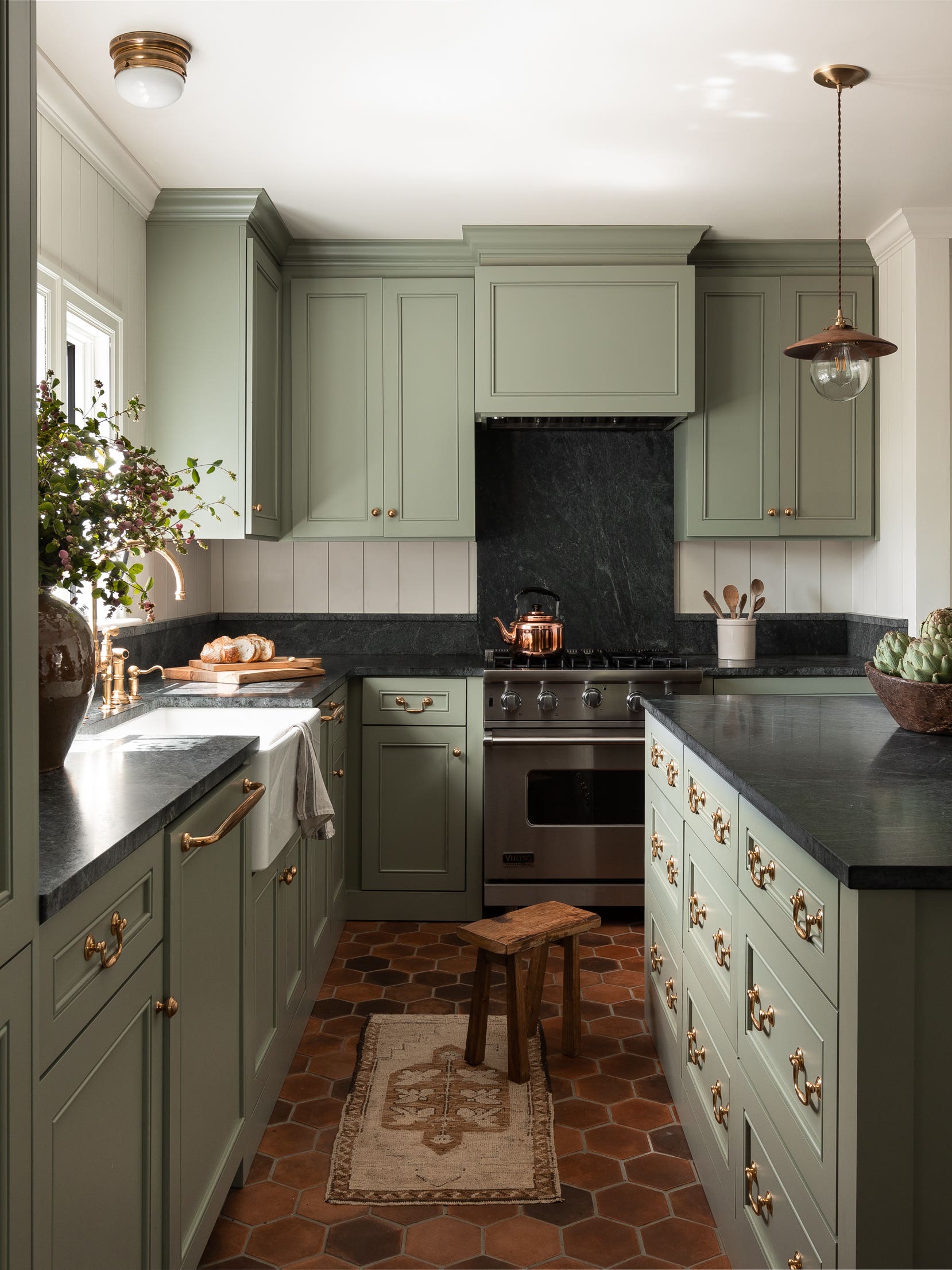 green kitchen with dark black counters