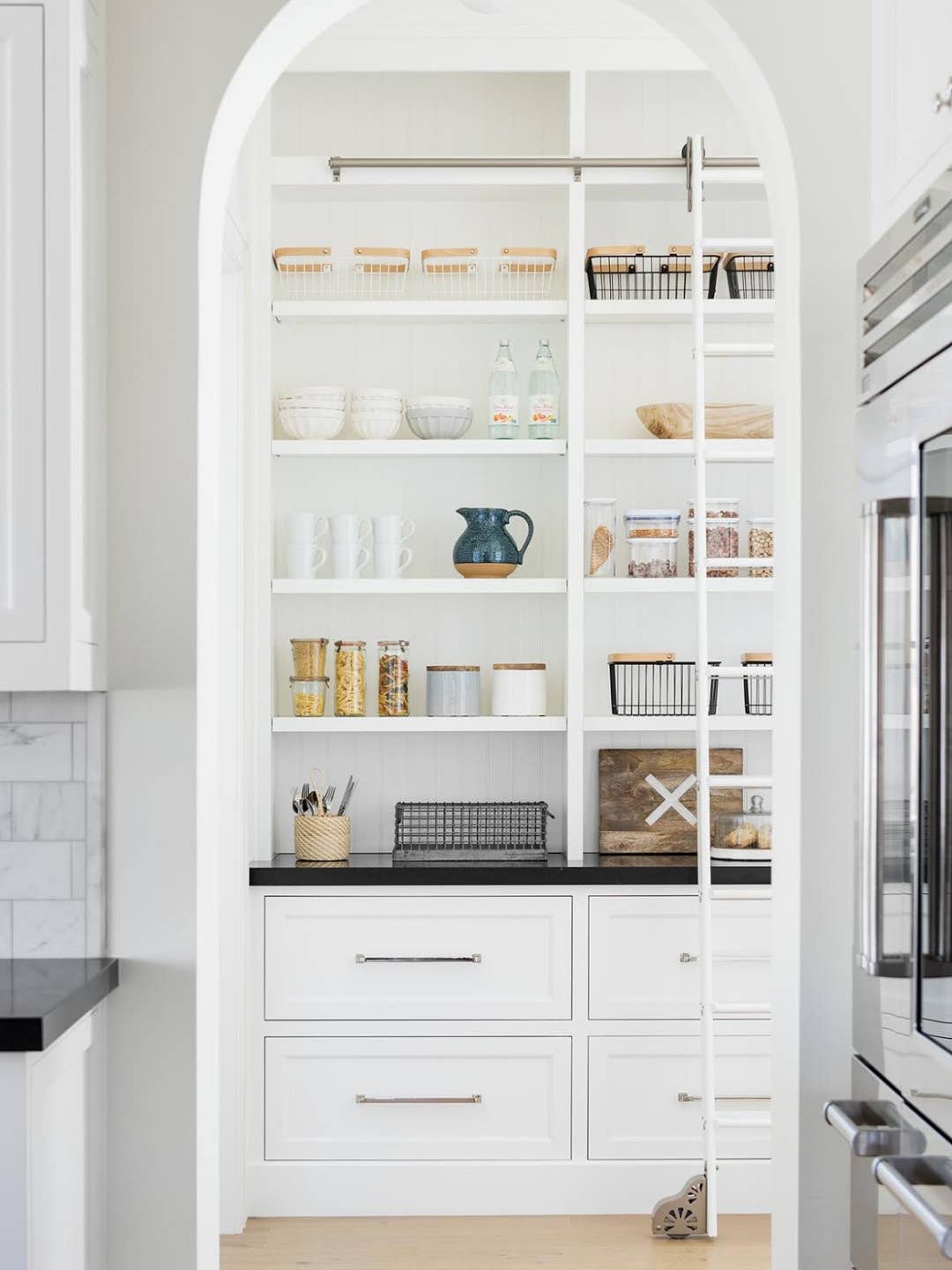 white kitchen pantry with arched ceiling