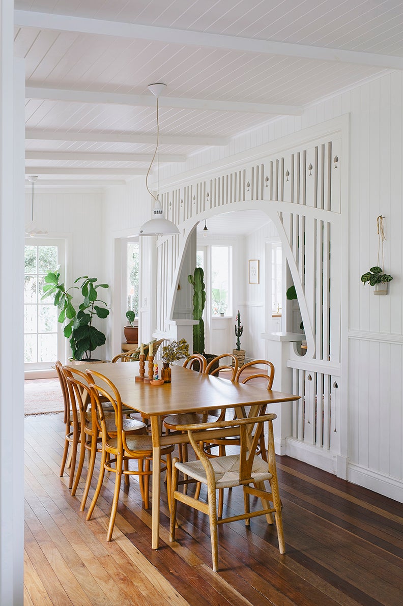 white dining room with wood table
