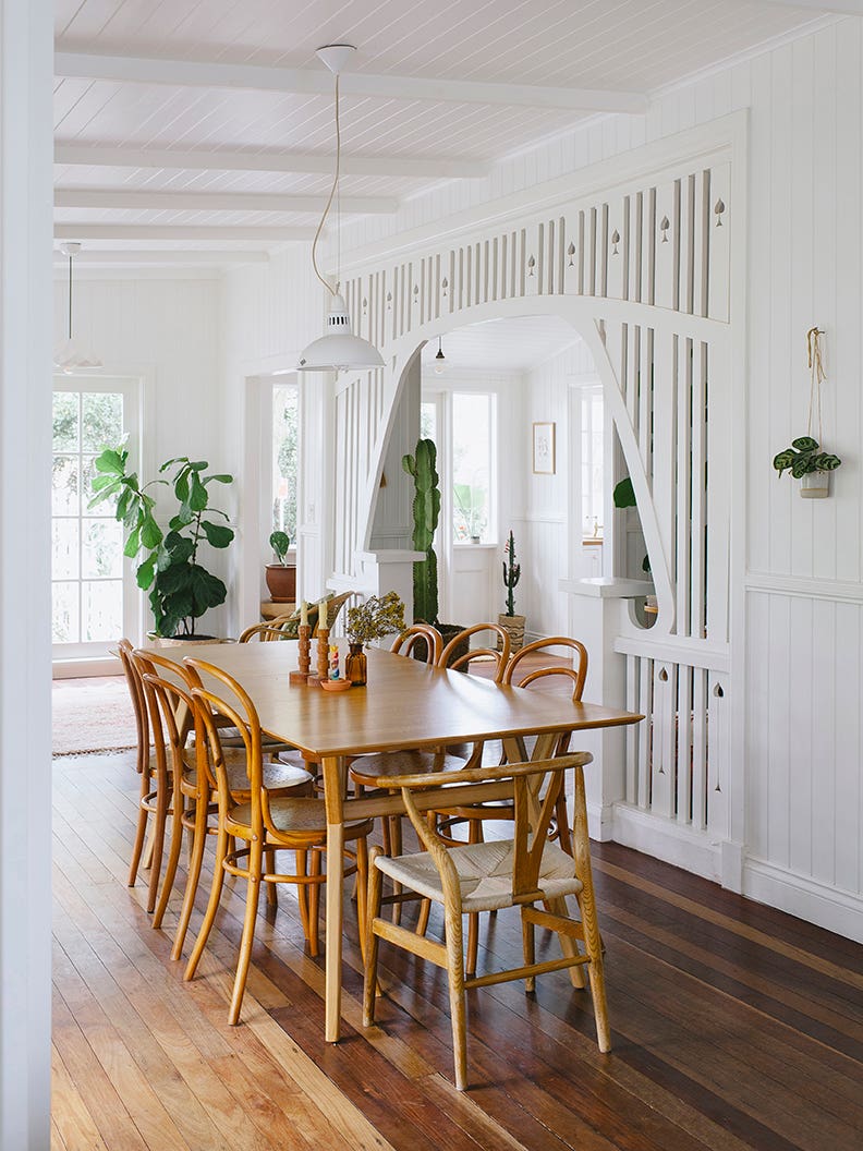 white dining room with wood table