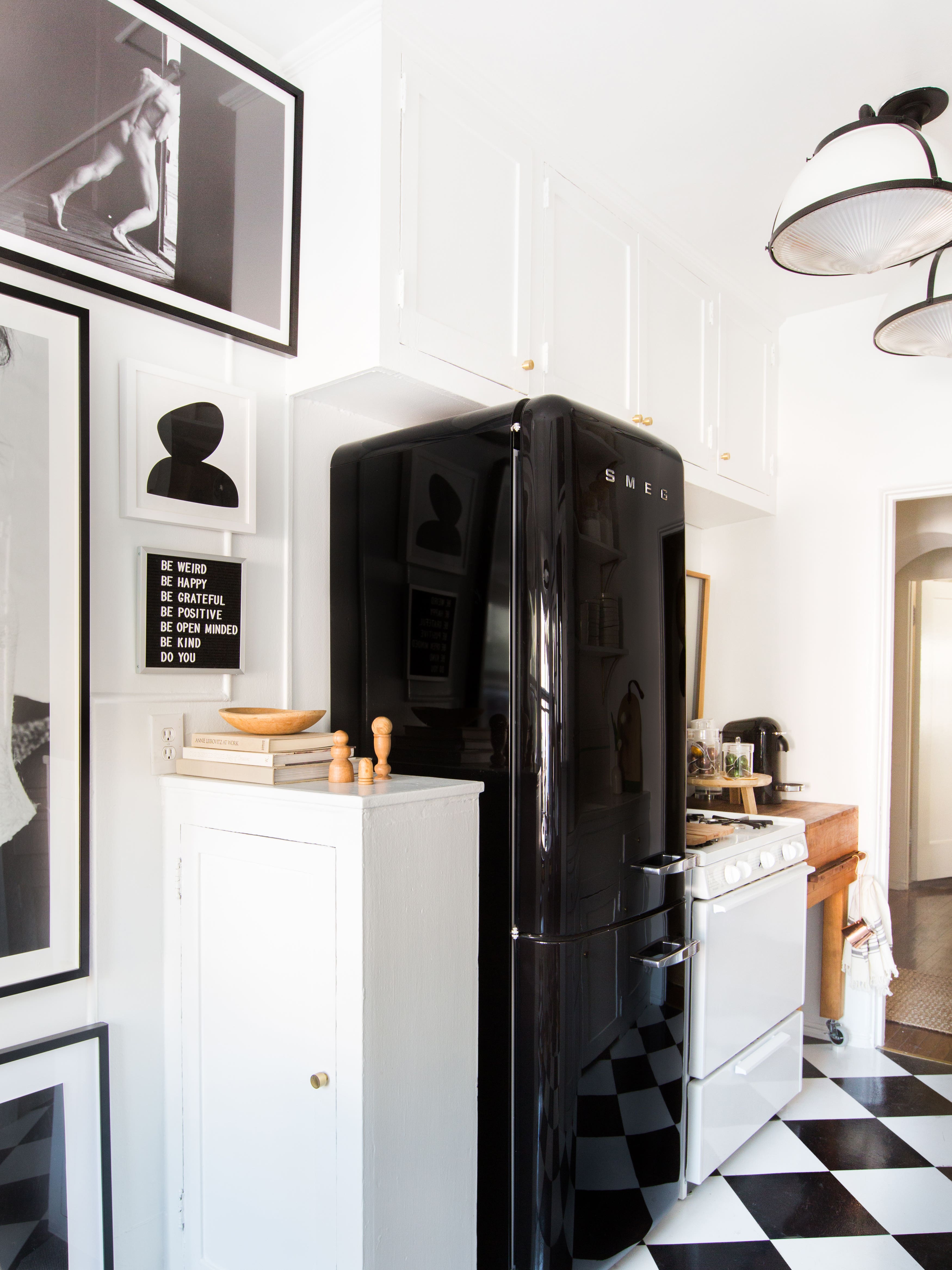 black fridge with balck and white checkered floors