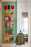 Kids room with starry green wallpaper and book shelves