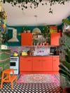 maximalist colorful kitchen with red cabinets
