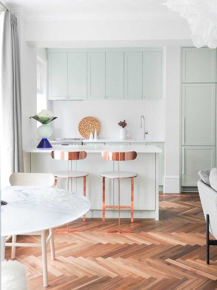 mint green kitchen in a apartment with herringbone floors
