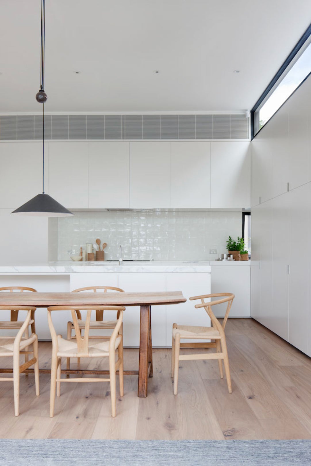 white kitchen with wood table