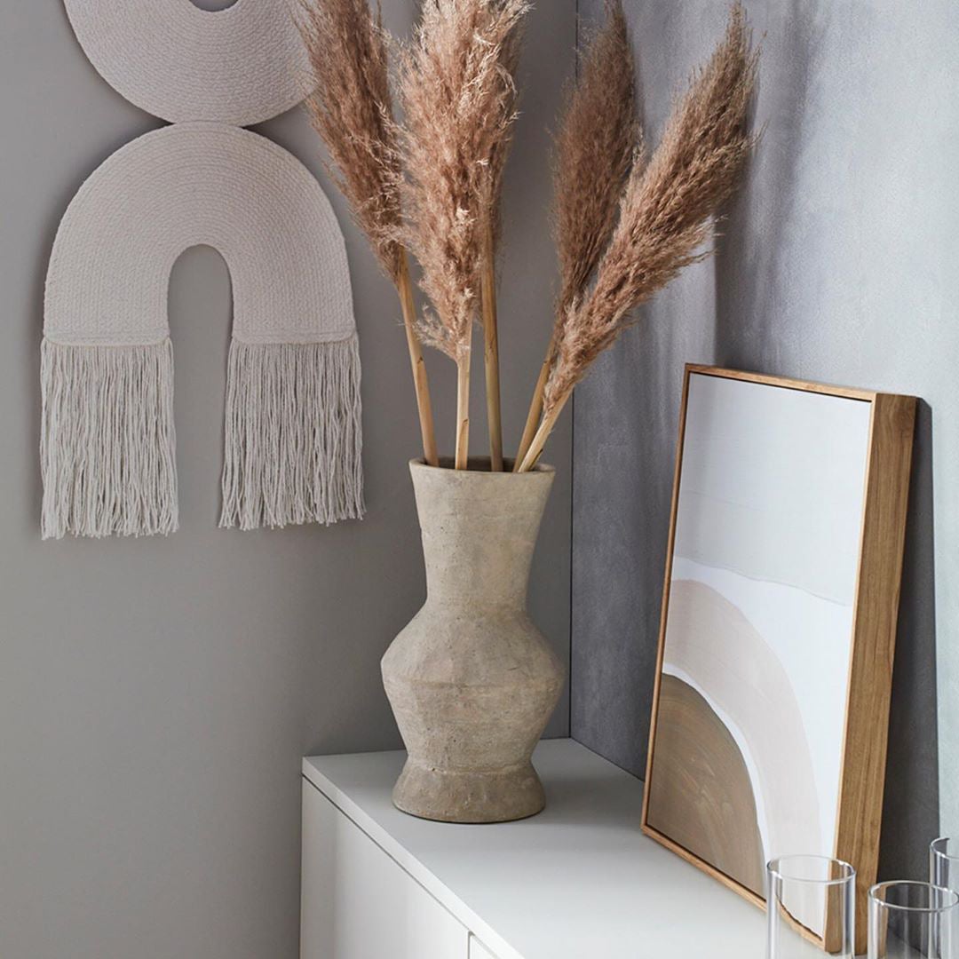 neutral vignette with rainbow wall hanging