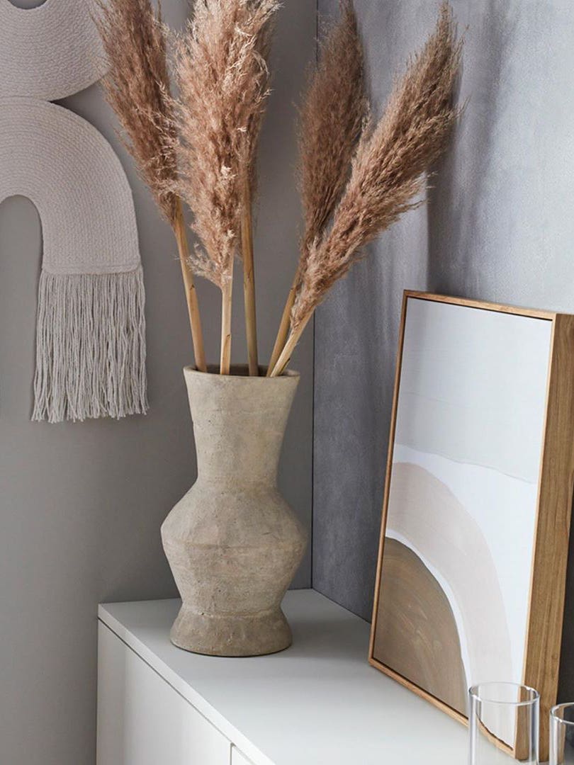 neutral vignette with rainbow wall hanging