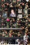 Entryway with dark floral wallpaper and gallery wall