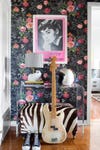 entryway with dark floral wallpaper and zebra print bench