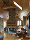 old cabin-style living room with stone fireplace