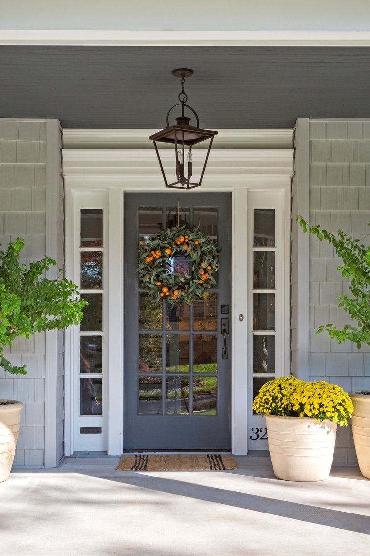 blue front door with an orange wreath