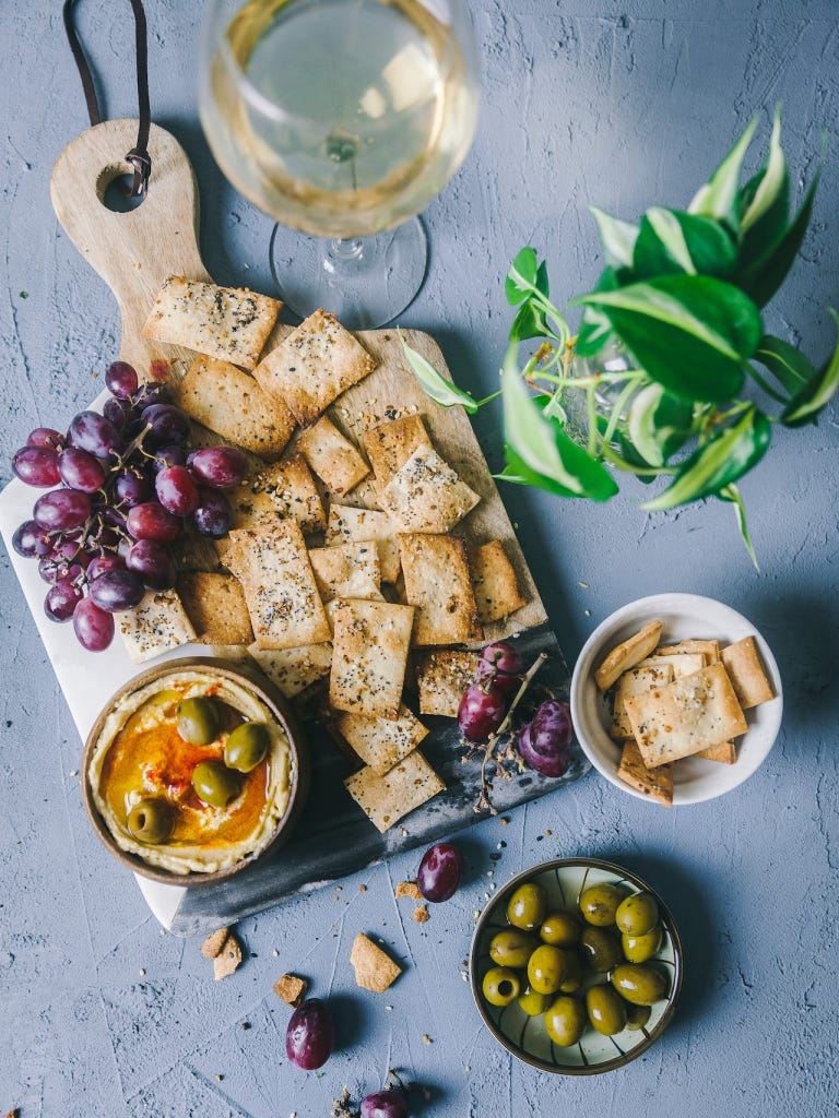 homemade crackers on a board with grapes