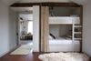 rustic grey bedroom with bunkbed and curtain