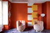 orange walsl and pink swivel chairs