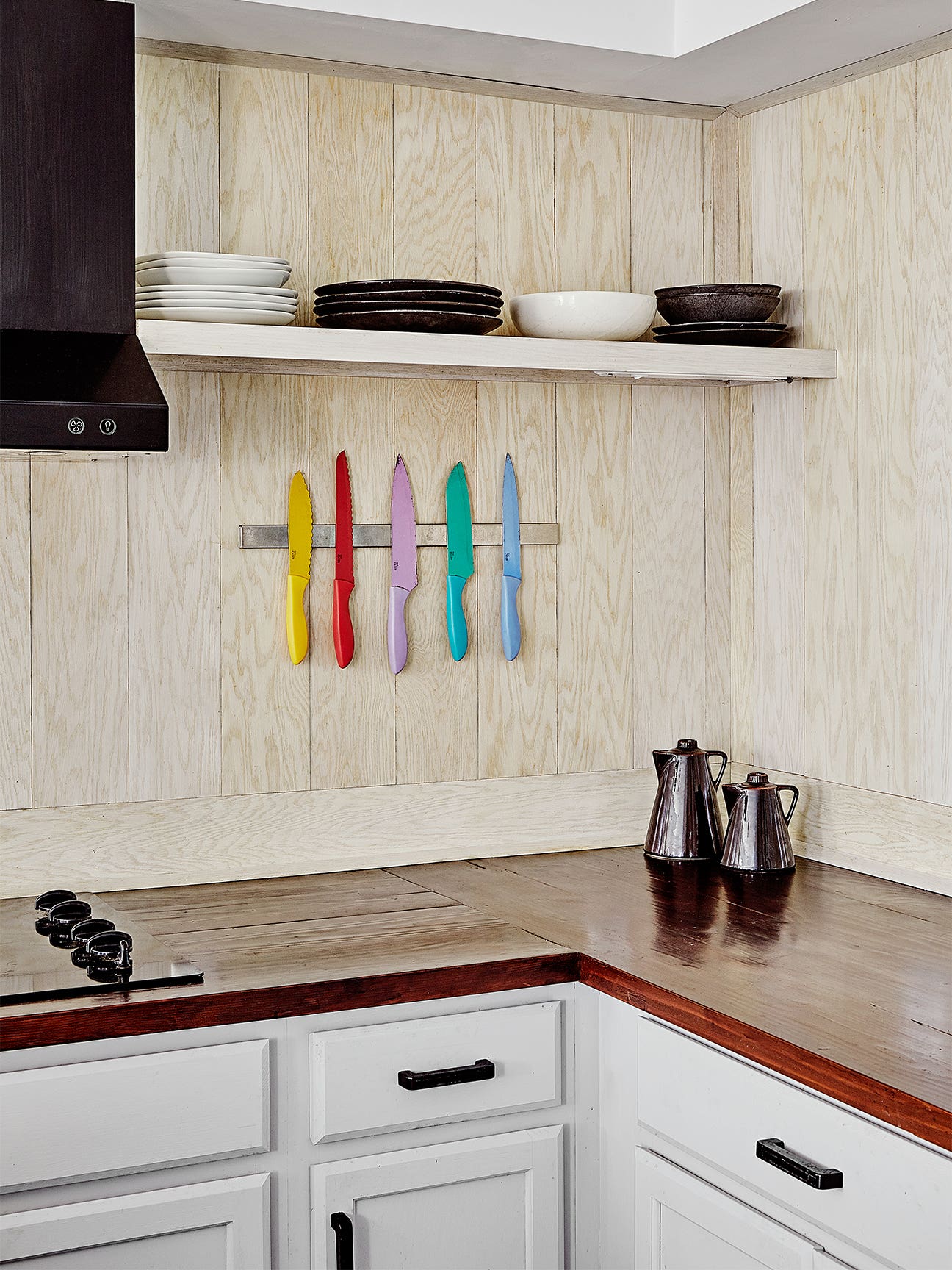 colorful knives on magnetic strip in kitchen