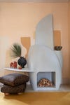 sculptural plaster fireplace with ah shelf