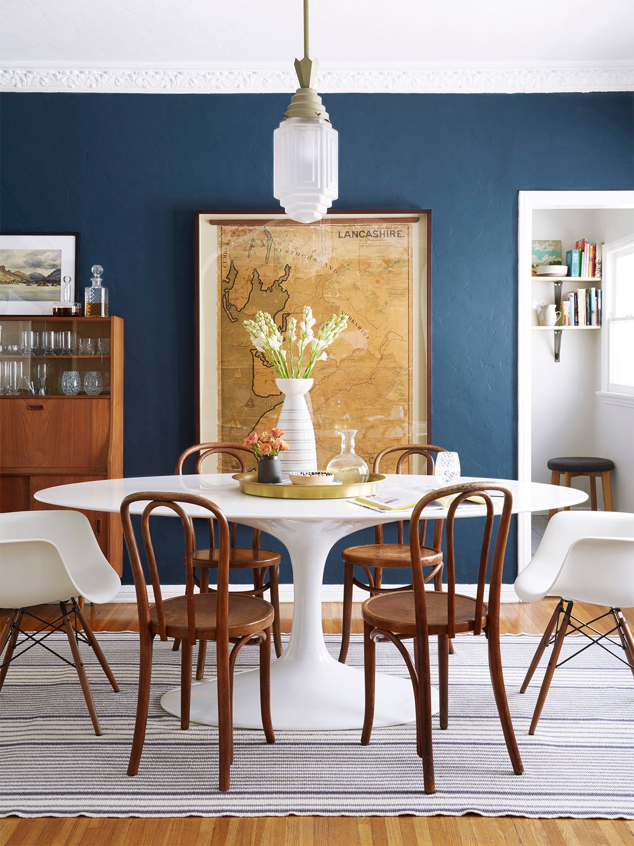 blue wall dining room with wooden chairs