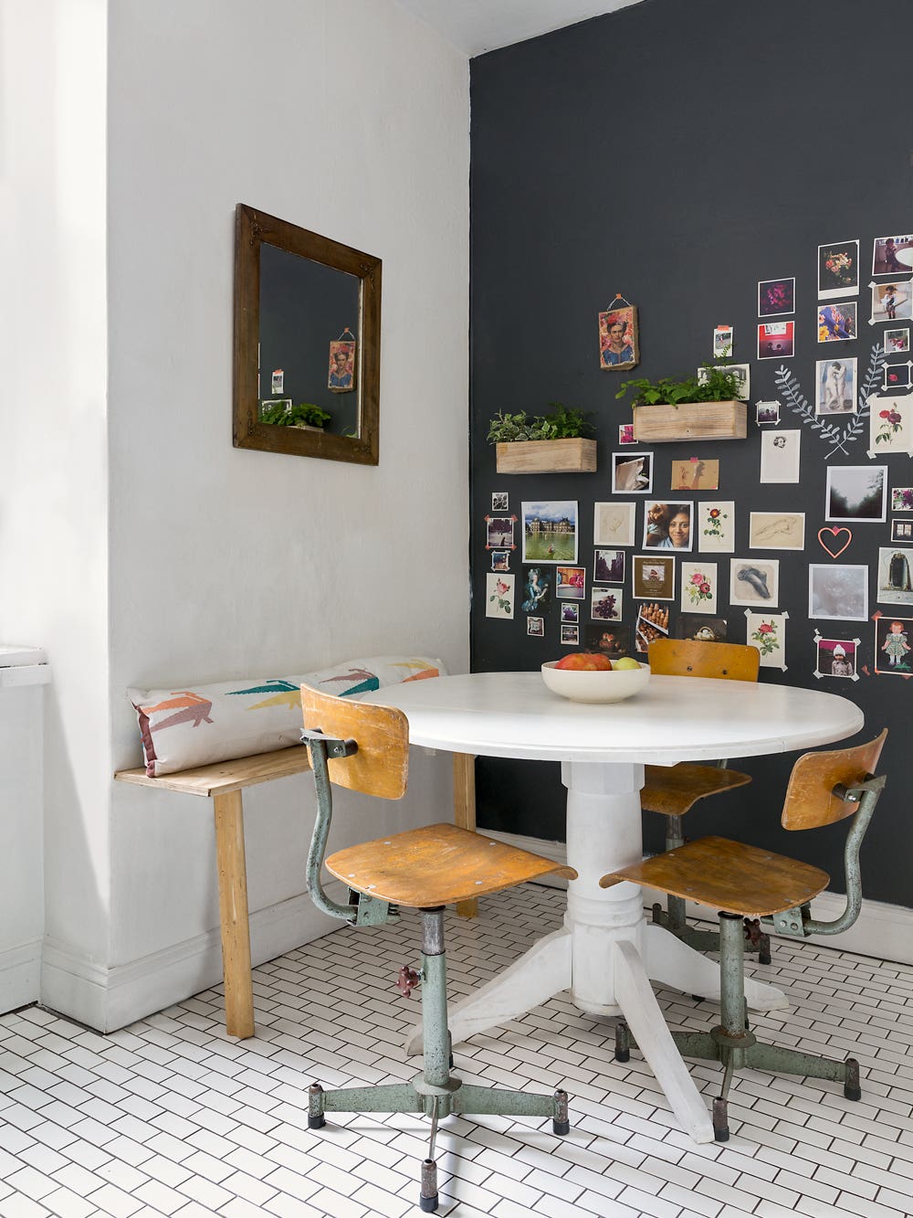 dining nook with black wall and art gallery