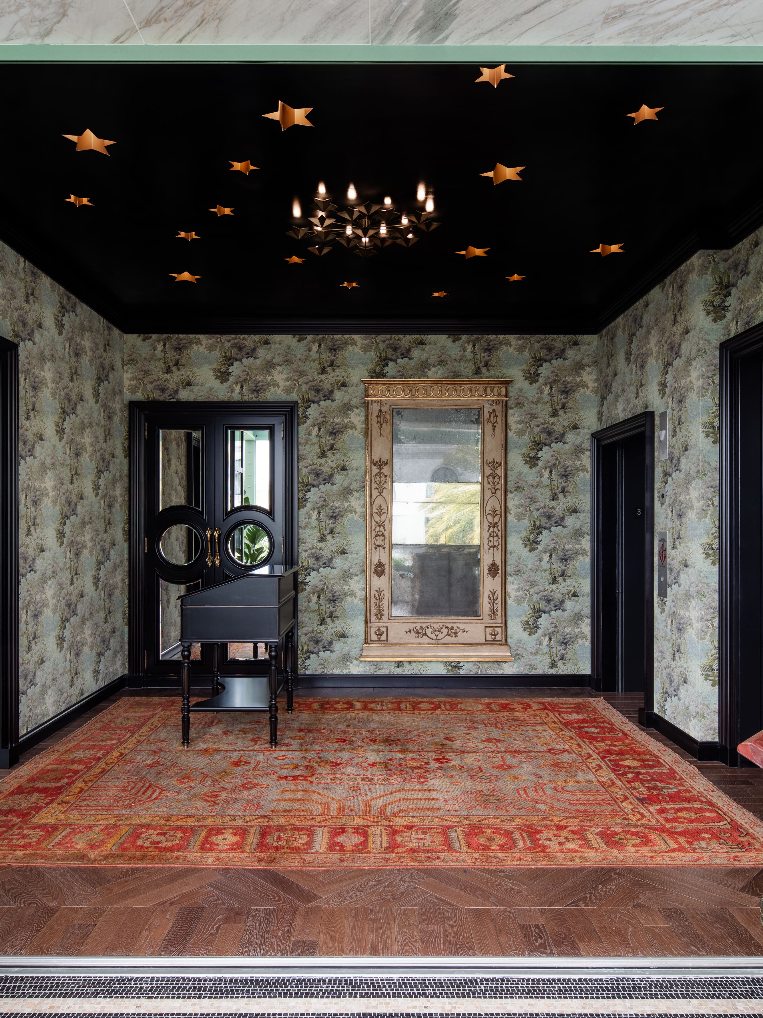 black ceiling entryway with red antique rug