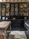 black kitchen with lots of glass doors