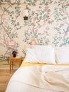 Room with floral wallpaper and bed on the floor