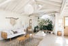 open and airy living room with white wood beams