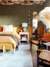colorful bedroom with ochre headboard