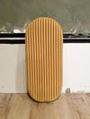 oval board covered in striped fabric