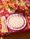 two ceramic plates on red floral tablecloth