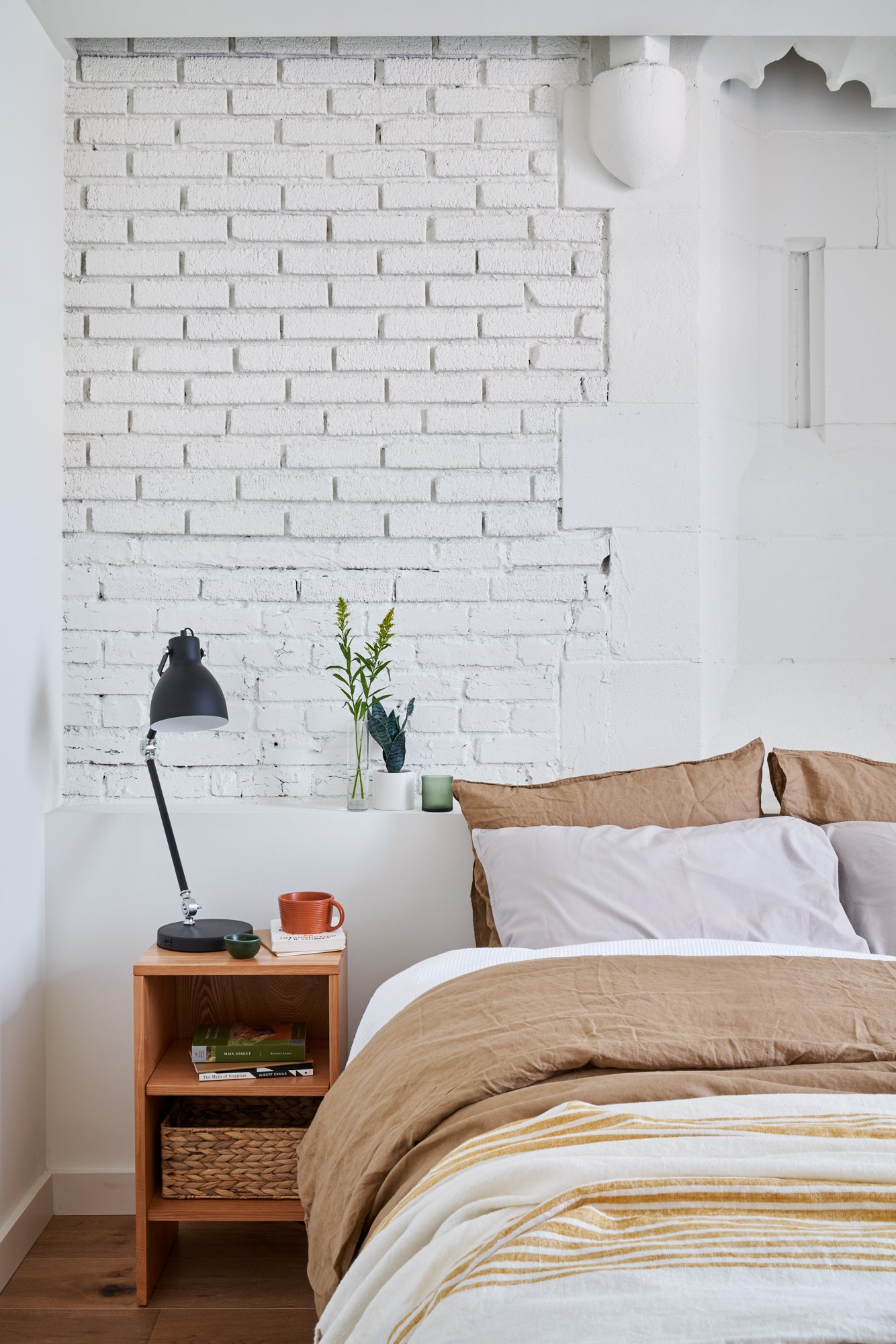 bedroom with white brick wall