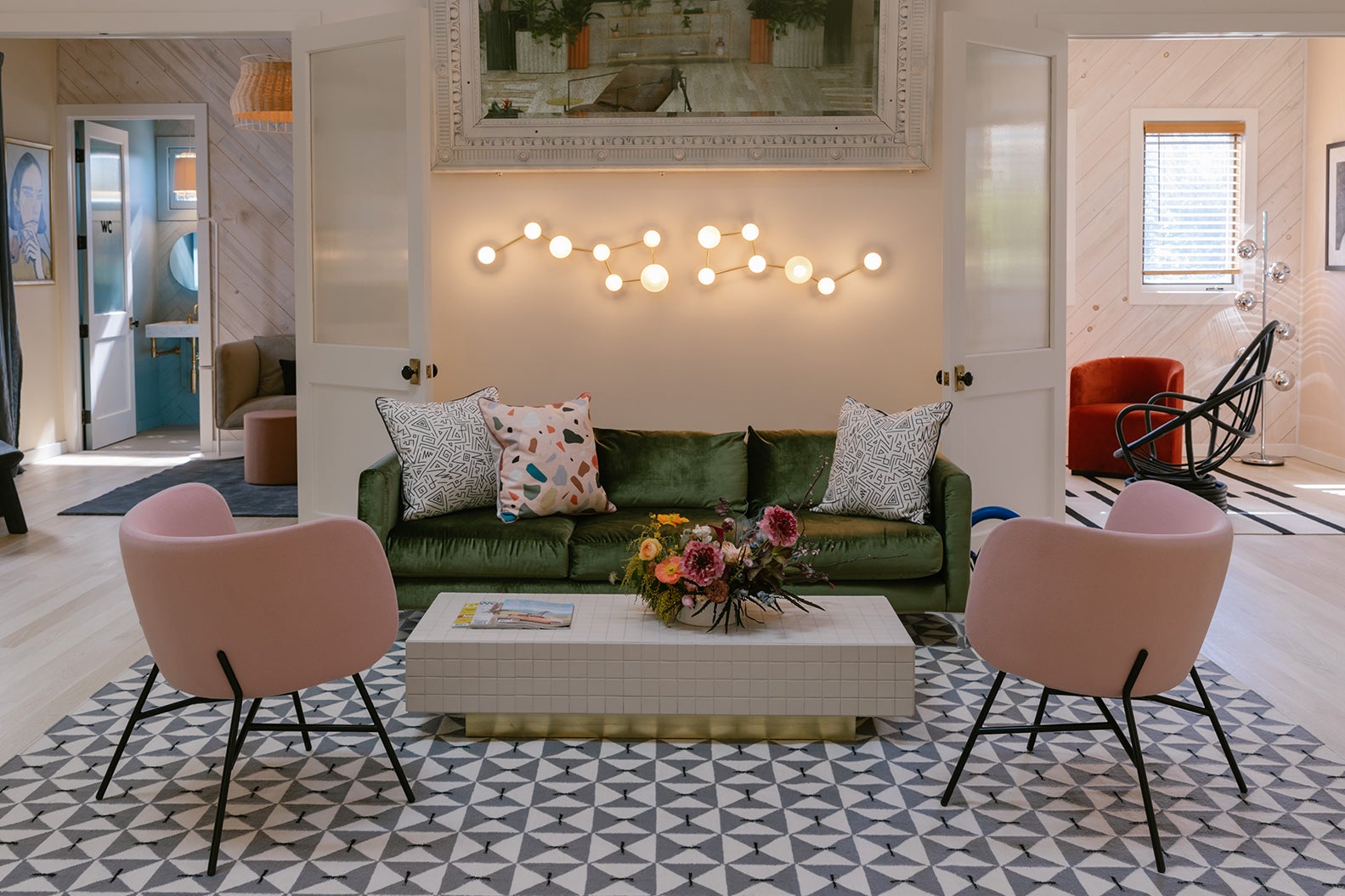 Space with green sofa and pink chairs