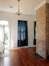 white entryway with exposed brick wall