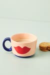 pink mug with red lip print on it