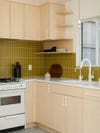 light wood cabinets and mustard yellow backslpahs tile