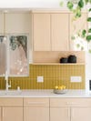 light wood cabinets and mustard yellow backslpahs tile