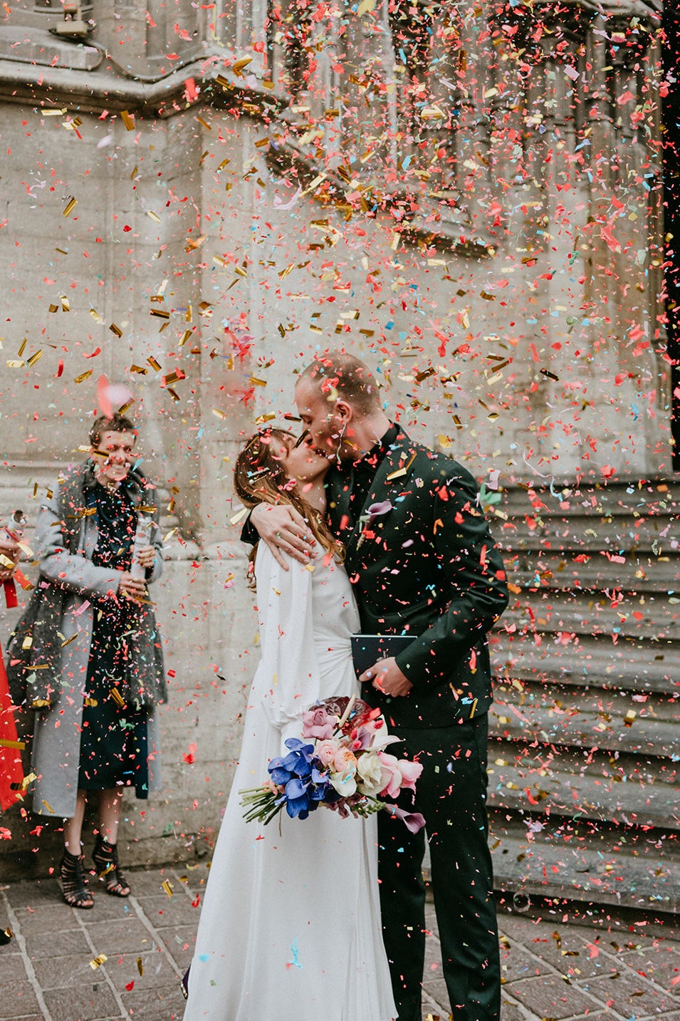 couple kissing with confettie falling on them