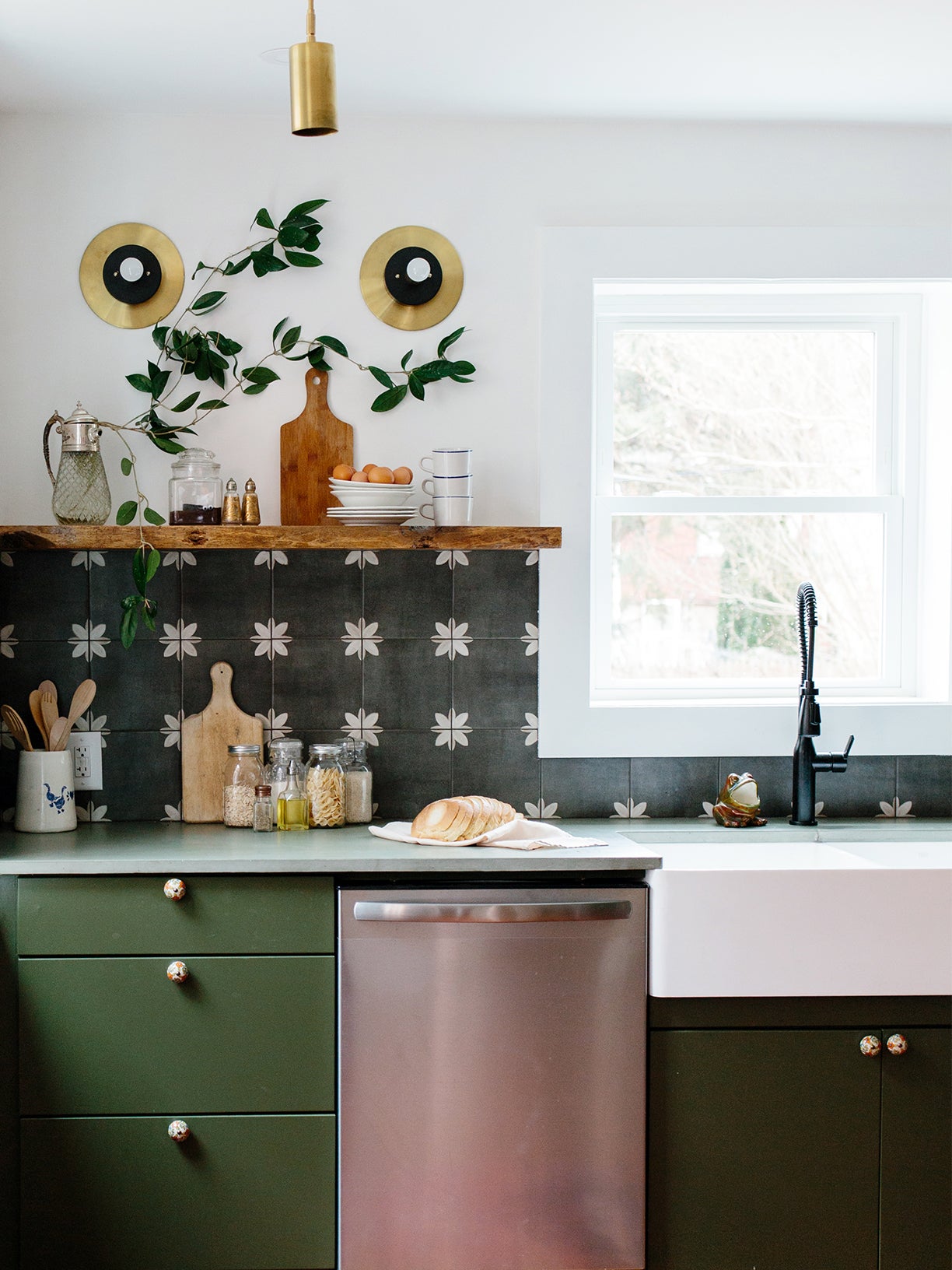 green kitchen with graphic black and white backsplash