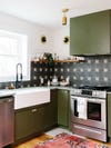green kitchen with graphic black and white backsplash