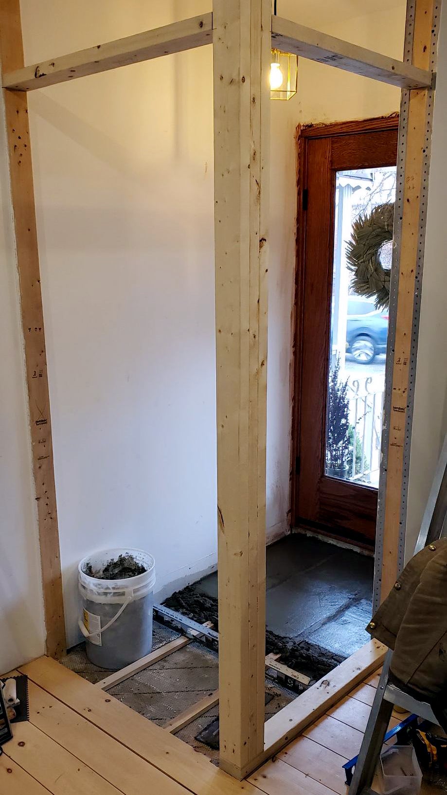wood framing and cement in an entry