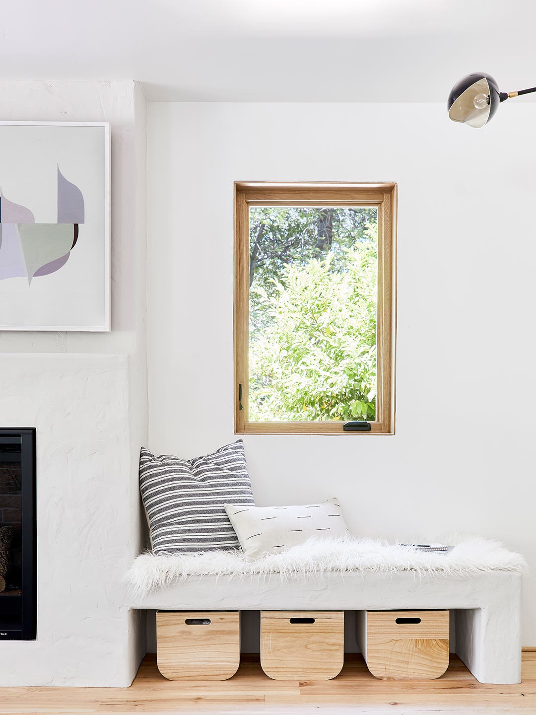 white room with reading nook under window