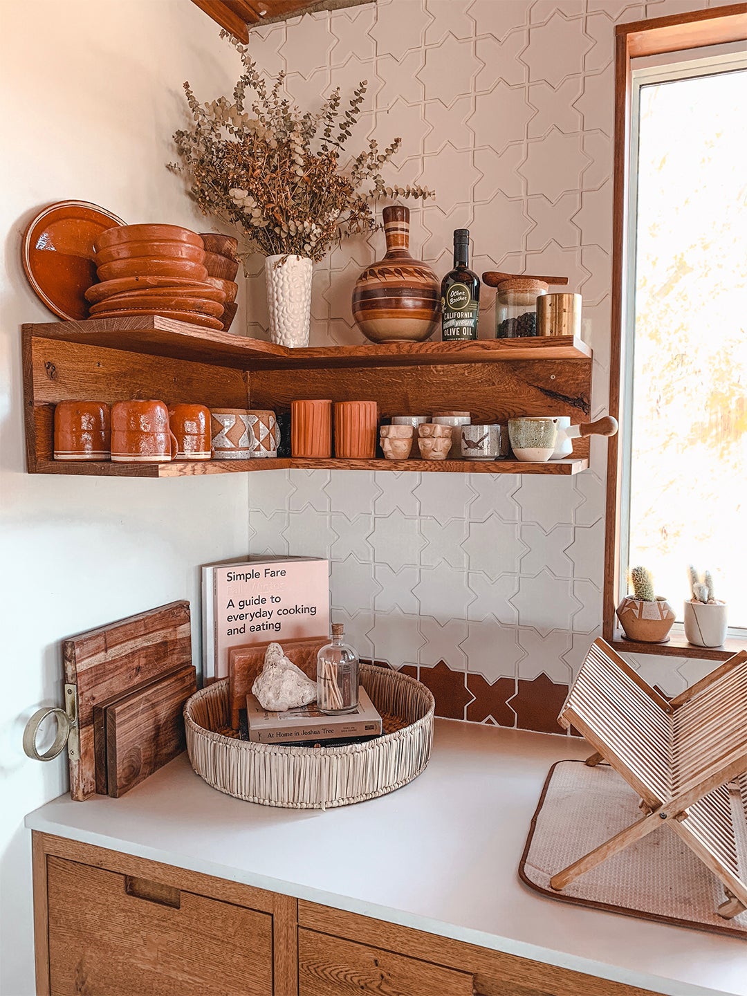 Open shelving with earth-toned mugs and pottery