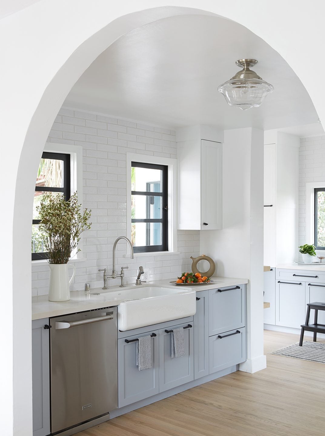 kitchen with blue cabinets and white archway