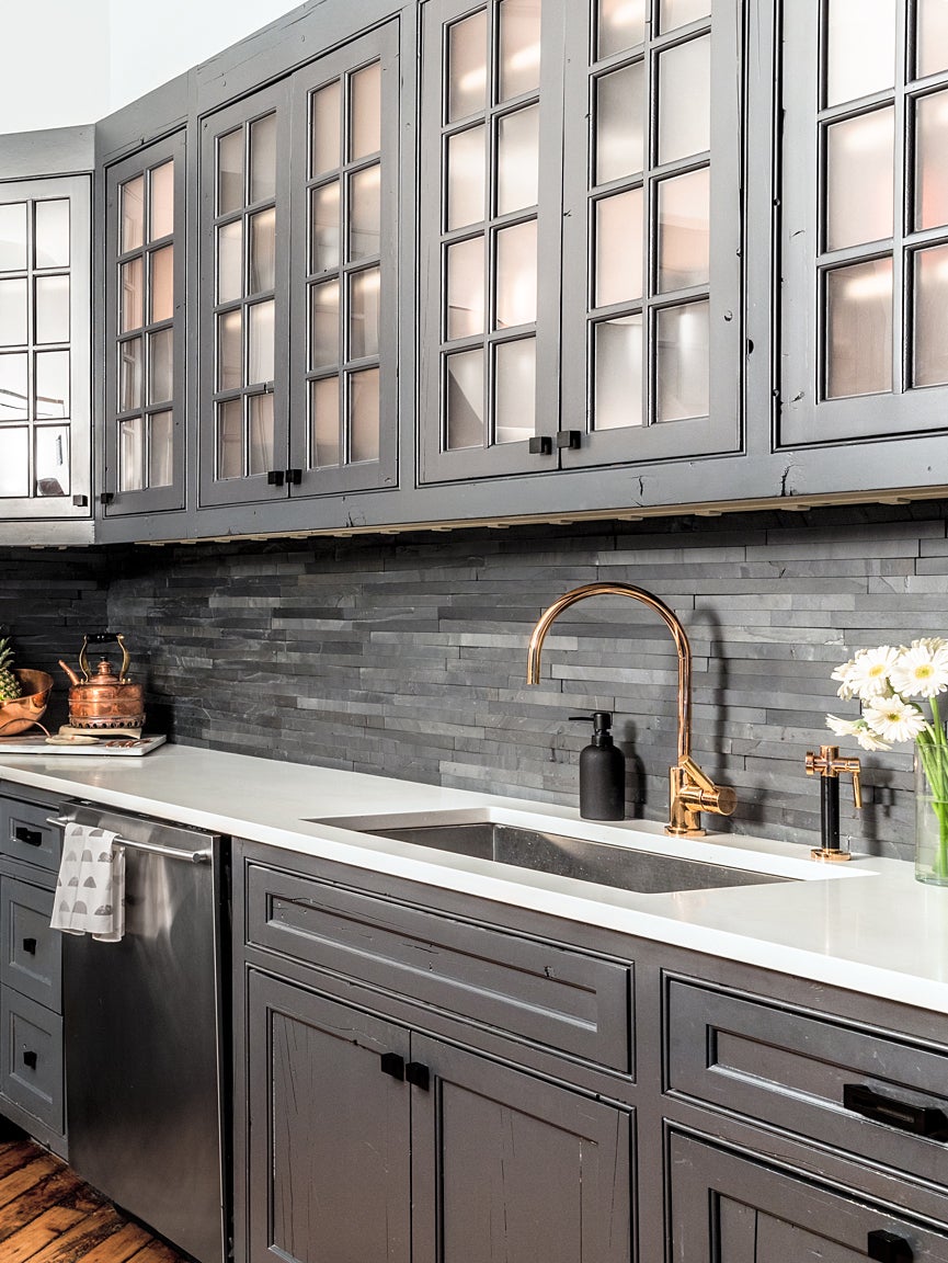 gray kitchen with copper faucet